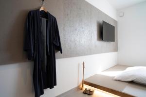 Rúm í herbergi á MASCOS HOTEL Masuda Onsen