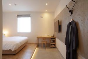 Rúm í herbergi á MASCOS HOTEL Masuda Onsen