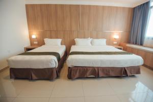 A bed or beds in a room at Hotel Sfera