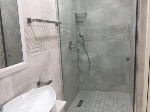a bathroom with a shower with a toilet and a sink at AYA LUXURY APARTMENTS 99 in Durban +14 photos
