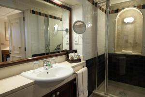 a bathroom with a sink and a shower at Columbia Beach Resort in Pissouri