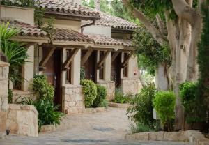 an exterior view of a house with a courtyard at Columbia Beach Resort in Pissouri
