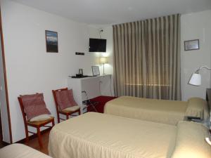 Postel nebo postele na pokoji v ubytování Hostal Coruña