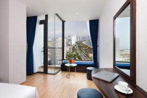 a living room with a table and a view of the city at Crown Hotel Nha Trang in Nha Trang