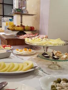 a buffet with plates of food on a table at Gombás Kúria Mansion Boutique B&B in Balatonfüred