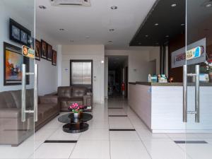 a lobby with couches and a bar in a building at Crescendo Boutique Hotel in Nusajaya