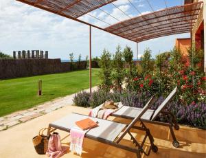 a patio with a table and chairs under a pergola at Trafalgar Polo Club in El Palmar