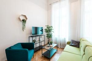 a living room filled with furniture and a window at Hybernska Apartments in Prague