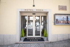 a hotel room door with a hotel rosa sign on it at Hotel Rosa in Baveno