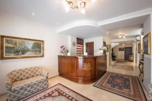 a living room with a chair and a table at Hotel Rosa in Baveno