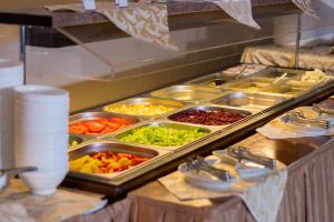 - un buffet avec de nombreux plateaux de légumes dans l'établissement AMAKS Park Hotel, à Tambov