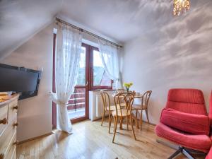 jadalnia ze stołem i krzesłami oraz oknem w obiekcie VisitZakopane - Himalaya Apartment w Zakopanem +6 zdjęć