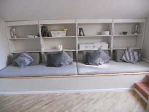 a bench with pillows on it in a room at B&B Poggio San Luca in Bologna