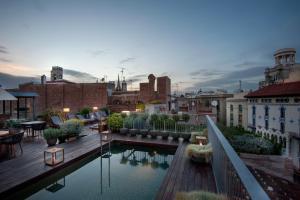 a rooftop patio with a pool on a building at Mercer Hotel Barcelona in Barcelona
