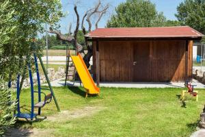 a playground with a slide and a building at Iris Hotel in Siviri