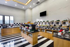 a restaurant with a buffet line with food on display at Crown Hotel Nha Trang in Nha Trang
