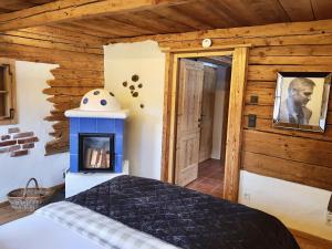 a bedroom with a fireplace in a log cabin at CHALET BELLE WILD by Belle Stay in Going am Wilden Kaiser