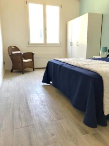 a bedroom with a bed and a wooden floor at Il Miraggio in Fregene