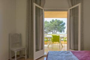 a bedroom with a door open to a patio with a table at Residencial Guardamar Zeus in Miami Platja +172 photos