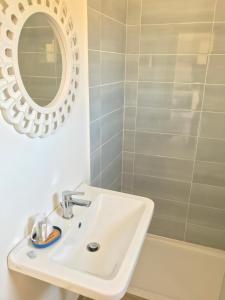 a bathroom with a white sink and a mirror at Il Miraggio in Fregene