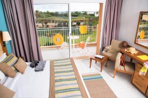 a living room with a view of a balcony at AQI Skanes Resort in Monastir