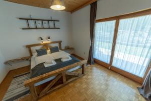 a bedroom with a bed and a large window at Haus Agnes, Murau in Murau