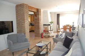 a living room with a couch and two chairs at Beautiful apartment private roof terrace in Nerja