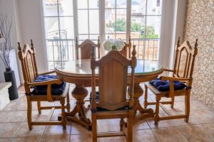 a dining room with a table and four chairs at Beautiful apartment private roof terrace in Nerja