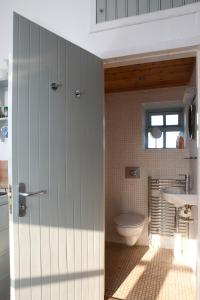 La salle de bains est pourvue de toilettes et d'un lavabo. dans l'établissement Charming old stables studio cottage, à Clonakilty