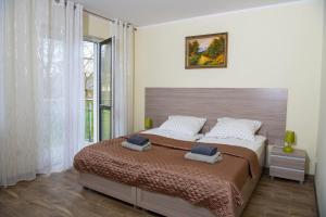 sypialnia z dużym łóżkiem i oknem w obiekcie Apartamenty Ewa II w Ustce