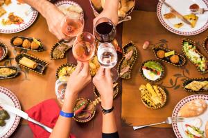 a group of people holding up wine glasses at a table at AQI Skanes Resort in Monastir