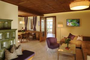 a living room with a couch and a table at Hotel & Gasthof Fürberg in Sankt Gilgen