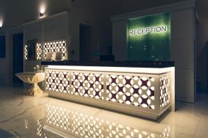 a reception counter with lights in a room at Hotel Perla Beach Luxury - All Inclusive & Free Beach Access in Primorsko