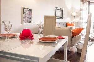 a dining room with a table with a candle on it at CHIC PANORAMIC APARTMENT in Bergamo