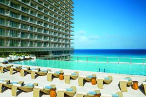 a view of the ocean from the pool at the resort at Secrets The Vine Cancun - All Inclusive Adults Only in Cancún