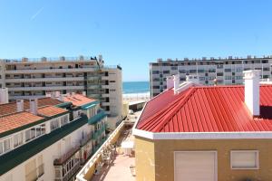 an aerial view of buildings and the beach at House Beach in Costa da Caparica