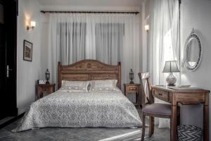 a bedroom with a bed and a desk and a mirror at Artemis Selcuk Suites in Selcuk