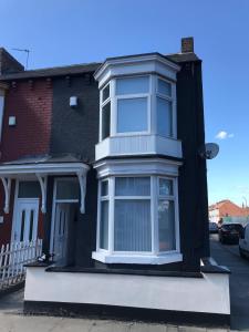 a black and white house with a window at Alphalink Apartment in Middlesbrough