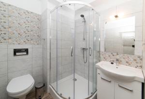 łazienka z prysznicem, toaletą i umywalką w obiekcie Apartamenty Ewa II w Ustce
