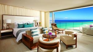 a hotel room with a bed and a large window at Secrets The Vine Cancun - All Inclusive Adults Only in Cancún
