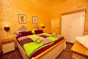 a bedroom with a large bed in a wooden room at Ferienhaus Orchidee in Rieden