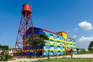 a colorful building with a water tower in front of it at 2U Hotel Hatyai in Hat Yai