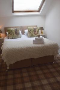 a bedroom with a large bed with a window at Harrogate Elite Living in Harrogate
