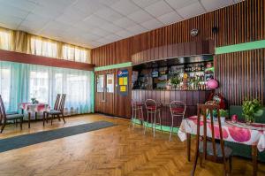 a restaurant with a bar with tables and chairs at OW Posejdon Jastarnia - blisko morza i nad zatoką in Jastarnia +27 photos