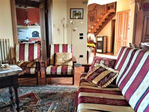 a living room with a couch and chairs at Villa in campagna Costa al Bagno in Montopoli in Val dʼArno