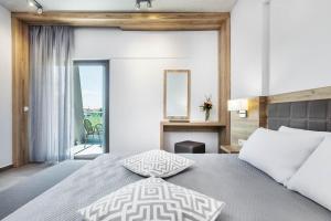 a bedroom with a king sized bed and a fireplace at Iris Hotel in Siviri