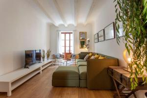 a living room with a couch and a fireplace at ApartUP Rojas Market in Valencia
