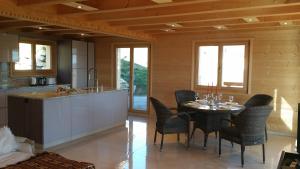 a kitchen and dining room with a table and chairs at Winterfell in Leysin