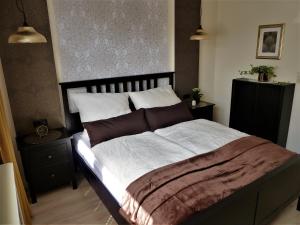 um quarto com uma cama grande com lençóis castanhos e brancos em Randersacker em Randersacker