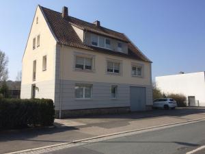 a white house with a car parked in front of it at Randersacker in Randersacker